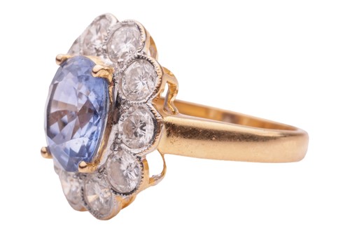 Lot 75 - A sapphire and diamond cluster ring in 18ct...
