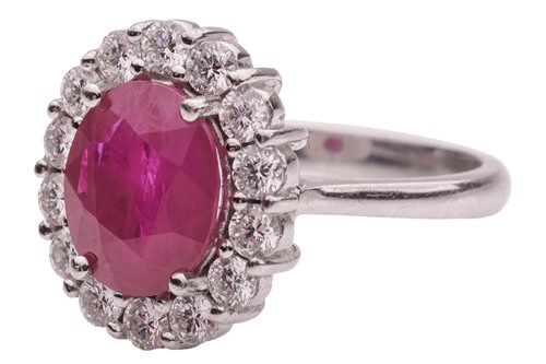 Lot 36 - A ruby and diamond cluster ring, comprising a...