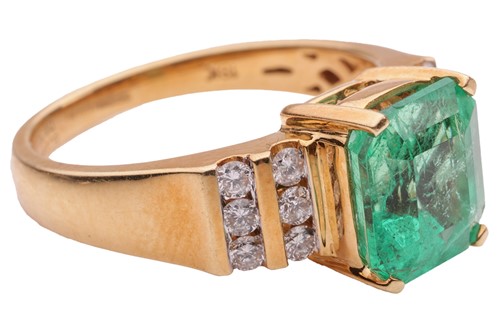 Lot 53 - An emerald and diamond dress ring in 18ct gold,...