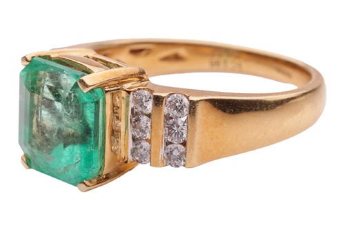 Lot 53 - An emerald and diamond dress ring in 18ct gold,...