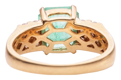 Lot 53 - An emerald and diamond dress ring in 18ct gold,...