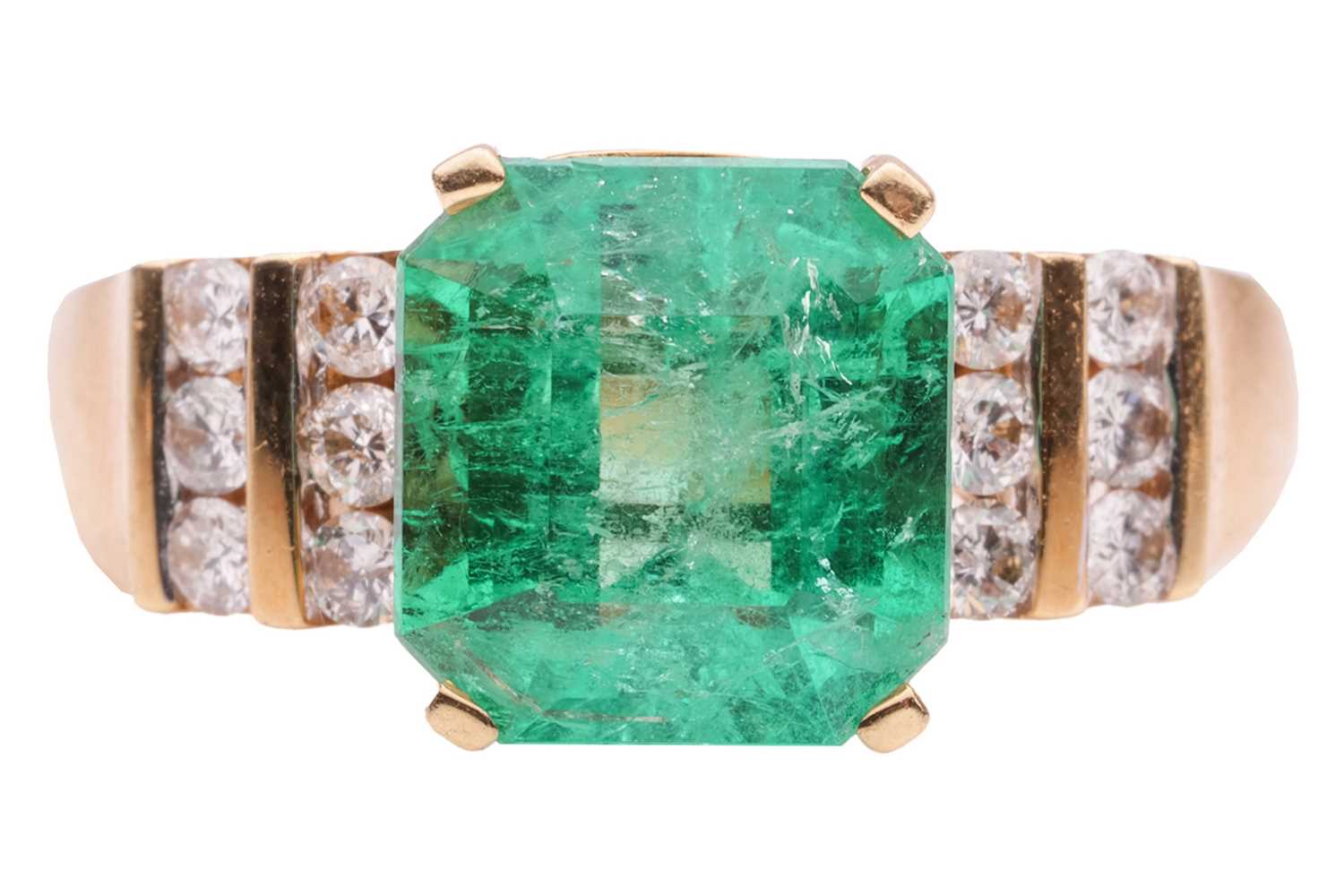 Lot 53 - An emerald and diamond dress ring in 18ct gold,...