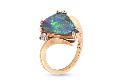 Lot 21 - A boulder opal dress ring, claw-set with a...