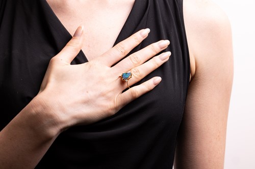 Lot 21 - A boulder opal dress ring, claw-set with a...