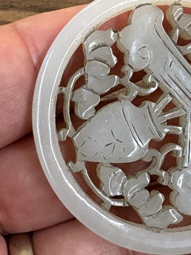 Lot 60 - A Chinese carved grey/green jade disk amulet...