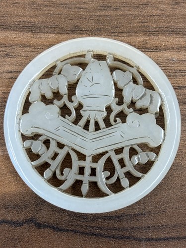Lot 60 - A Chinese carved grey/green jade disk amulet...