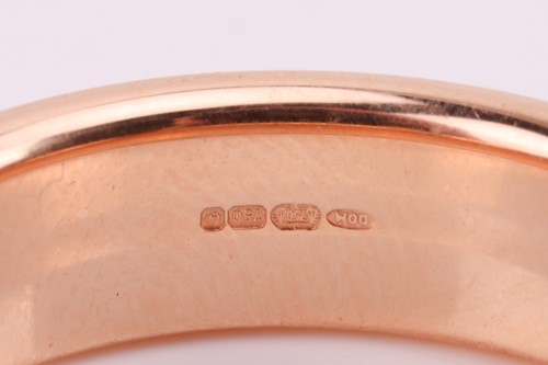Lot 40 - A brush-finished ring band in 18ct gold, with...