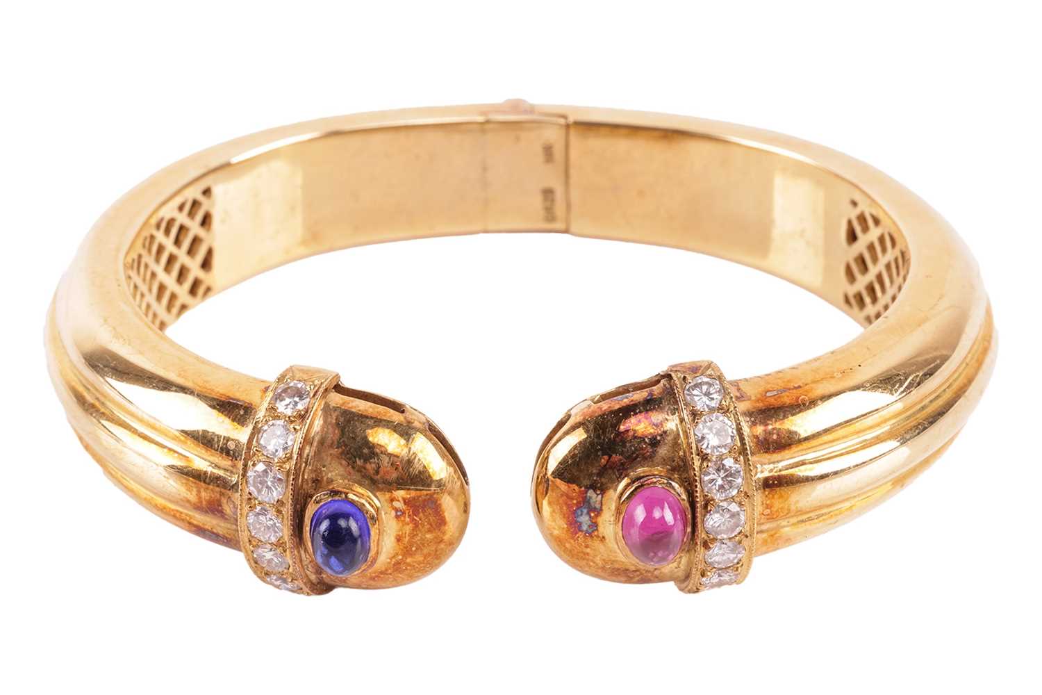 Lot 49 - A ruby, sapphire and diamond hinged torque...