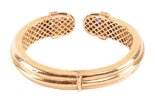 Lot 49 - A ruby, sapphire and diamond hinged torque...