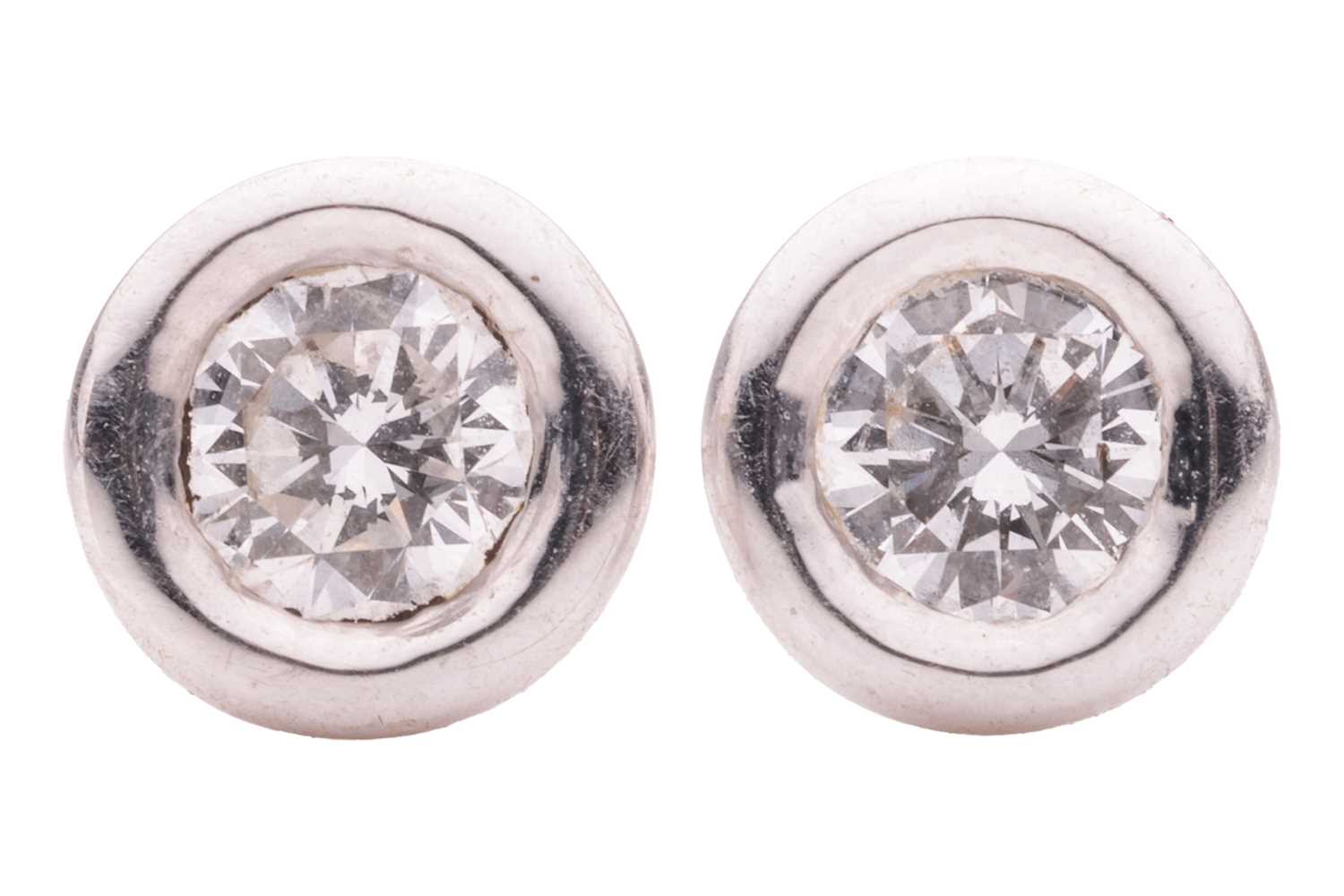 Lot 131 - A pair of diamond earstuds, with an estimated...