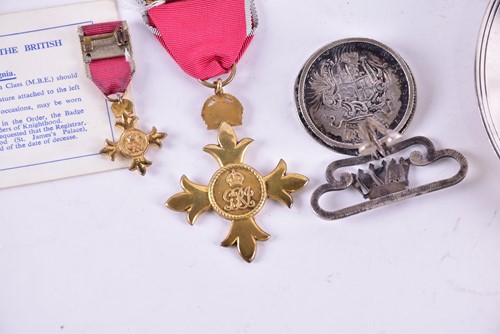 Lot 2 - A gilt metal O.B.E. medal on red ribbon...