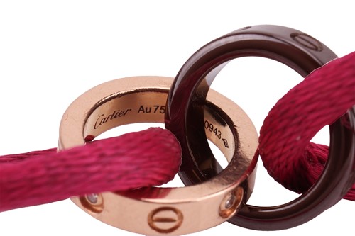Lot 77 - Cartier - a 'Love Charity' bracelet, featuring...