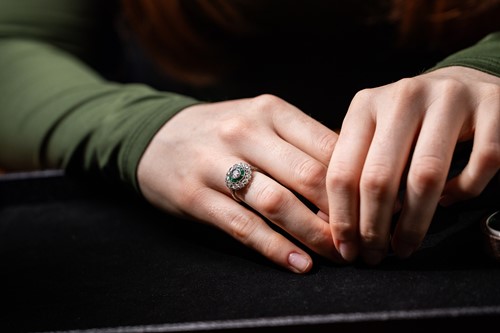 Lot 240 - An Art Deco diamond and emerald target ring,...