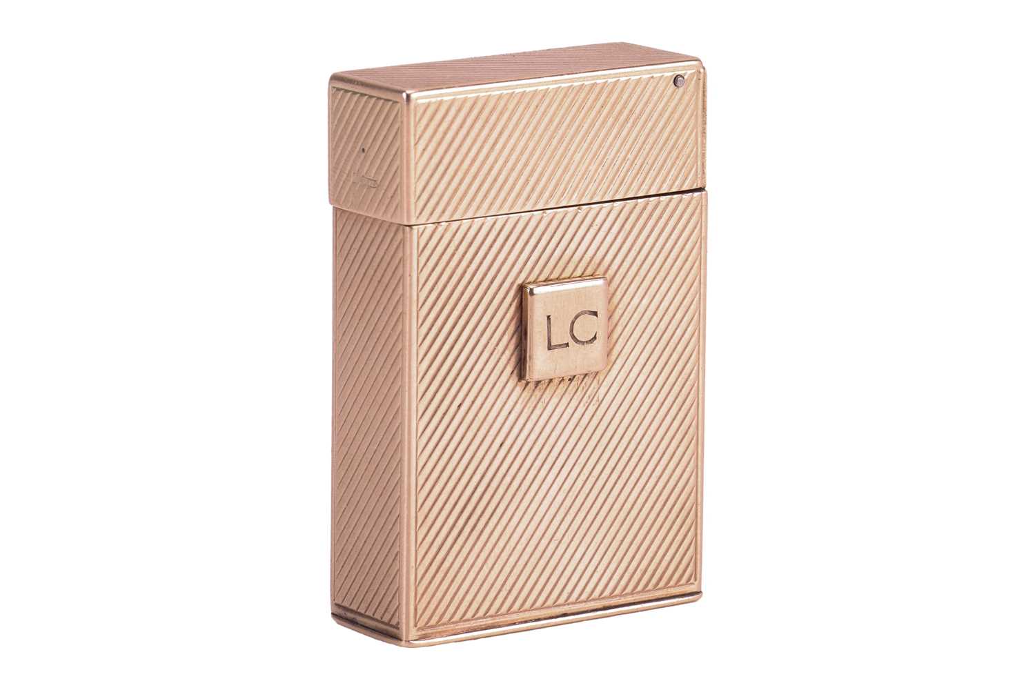 Lot 312 - Cartier - a 9ct gold lighter, of upright...