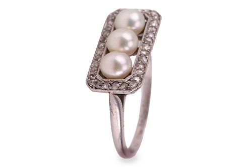 Lot 63 - An early 20th Century pearl trilogy ring; the...