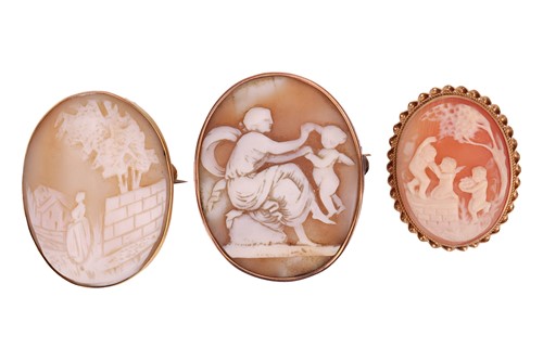 Lot 14 - Three cameo brooches; including an oval shell...