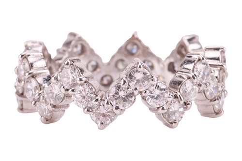 Lot A diamond set eternity ring, of zig zag design;...