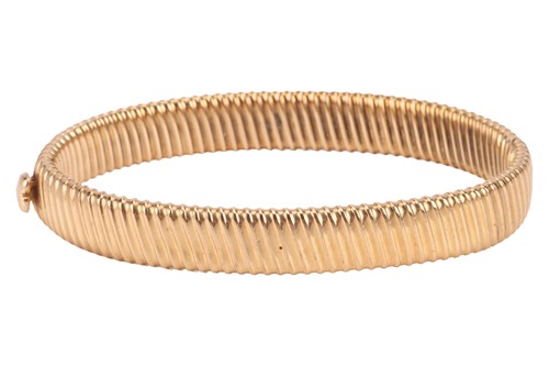 Lot A reeded hinged bangle, two hollow halves with...