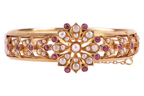 Lot A late 19th-century gem-set hinged bangle,...