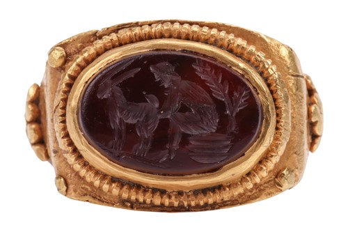 Lot A Roman sardonyx intaglio ring, the oval panel...