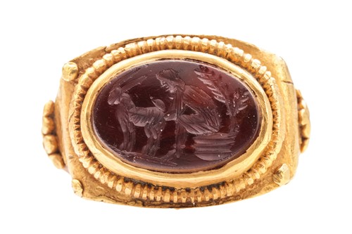 Lot 233 - A Roman sardonyx intaglio ring, the oval panel...