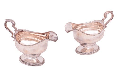 Lot 373 - A pair of George III silver pedestal sauce...