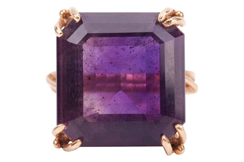 Lot An amethyst cocktail ring, containing a large...