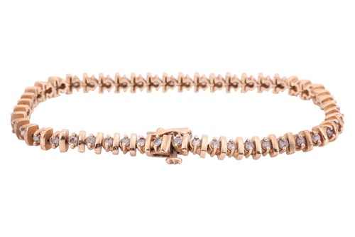 Lot A diamond-set line bracelet; comprising...