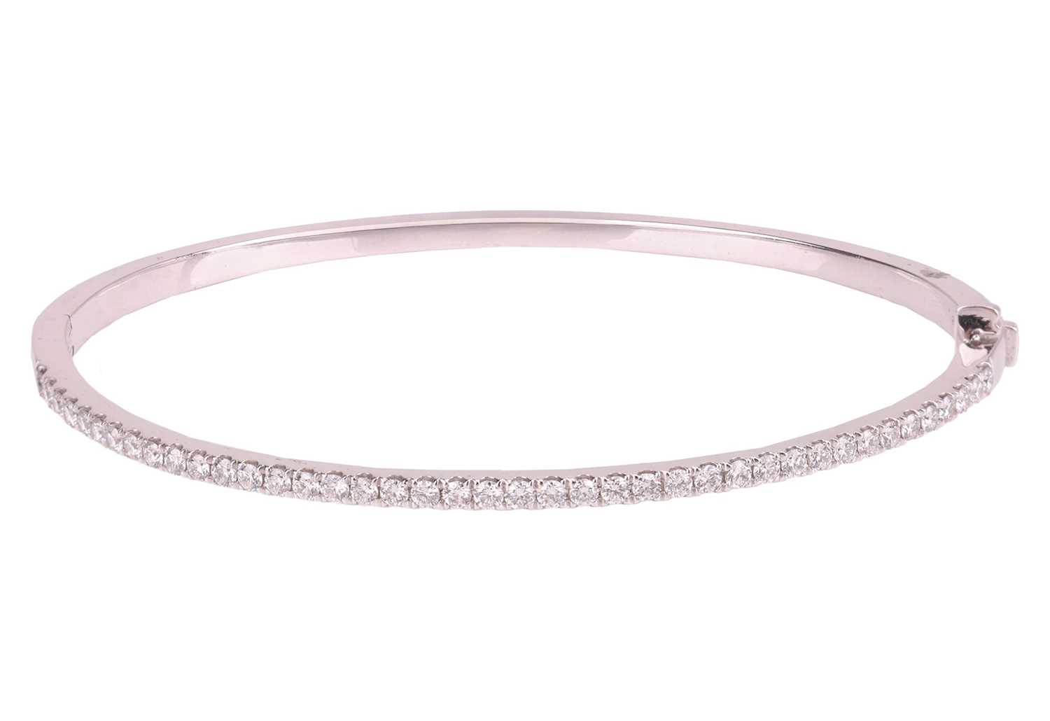 Lot 160 - A diamond-set hinged bangle in platinum,