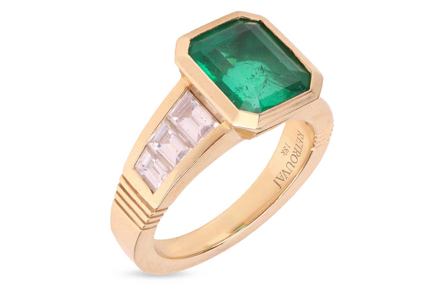 An emerald and diamond dress ring