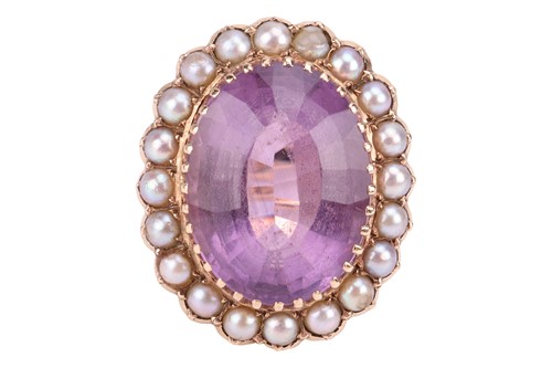 Lot 10 - An amethyst and split pearl halo ring, centred...