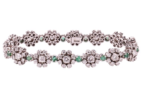 Lot 293 - A diamond and emerald floral cluster bracelet,...