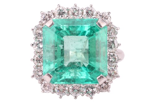 Lot 229 - A Colombian emerald and diamond halo ring, the...