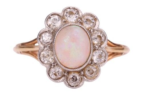 Lot 209 - An opal and diamond halo ring, centred with an...