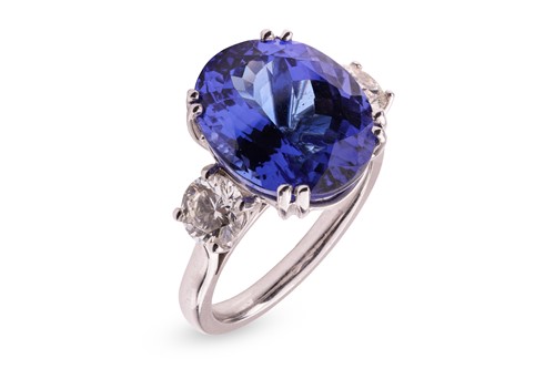 Lot 55 - A tanzanite and diamond trilogy ring in 18ct...