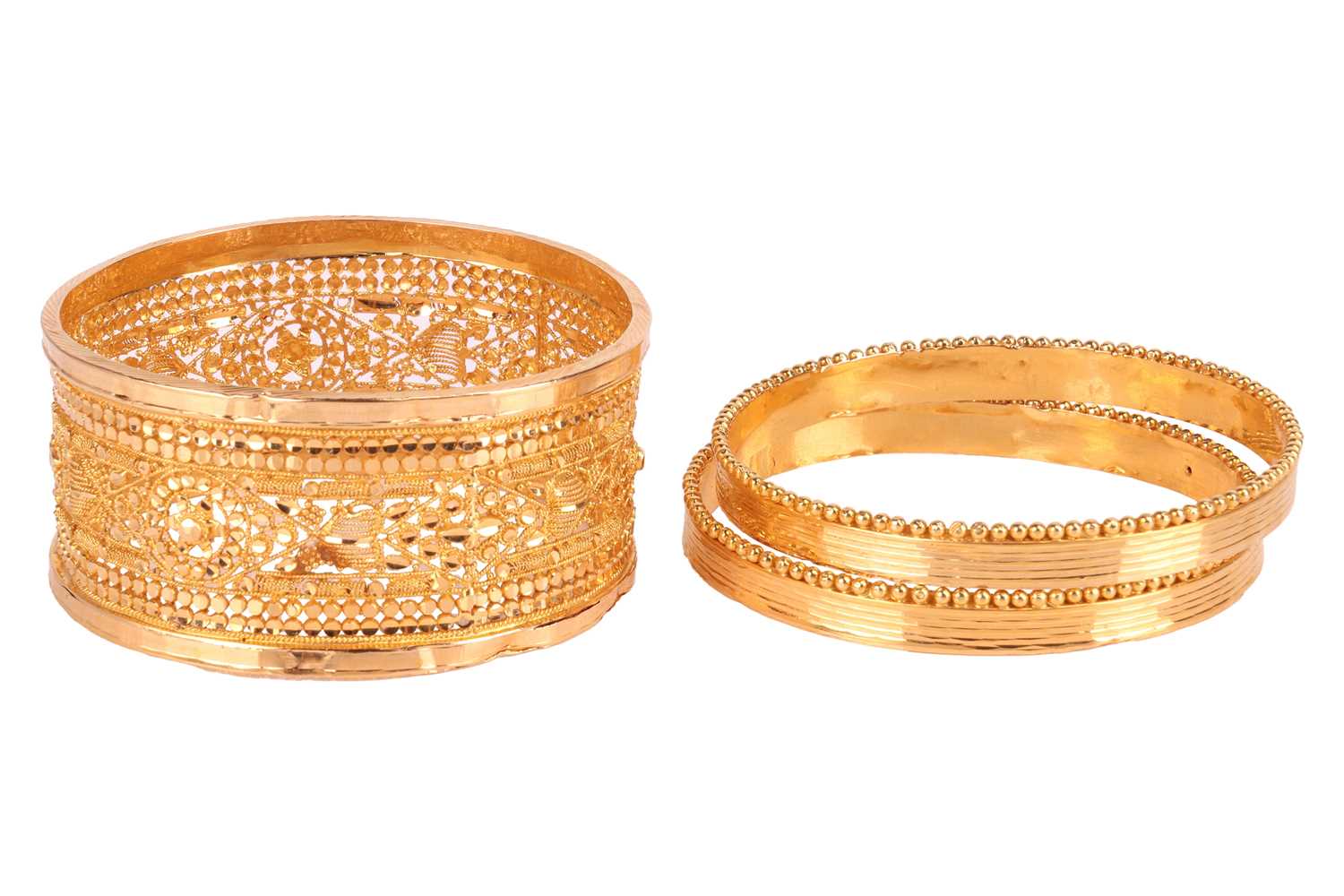 Lot 151 - Three closed bangles; the first bangle with...