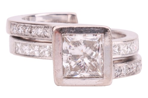 Lot 231 - A princess-cut diamond solitaire ring in 18ct...
