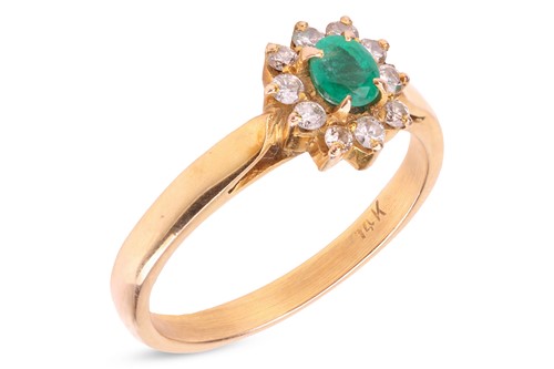 Lot 63 - An emerald and diamond cluster ring, centred...