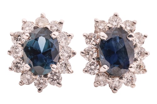 Lot 19 - A pair of sapphire and diamond cluster stud...