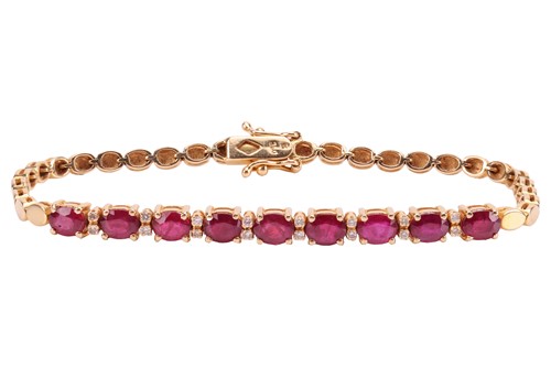 Lot 146 - A ruby line bracelet, claw-set with nine...