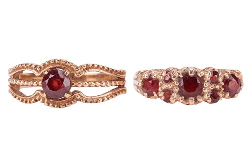 Lot 40 - Two garnet-set dress rings in 9ct yellow gold;...
