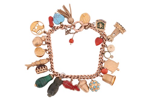 Lot 192 - A charm bracelet in 9ct gold, the curb link...