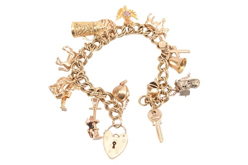 Lot 179 - A charm bracelet in 9ct gold, comprising a...