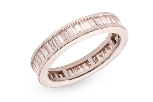 Lot A diamond eternity ring, channel-set with an...