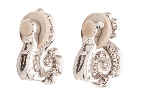 Lot 267 - Cartier - a pair of diamond-set scrolling...
