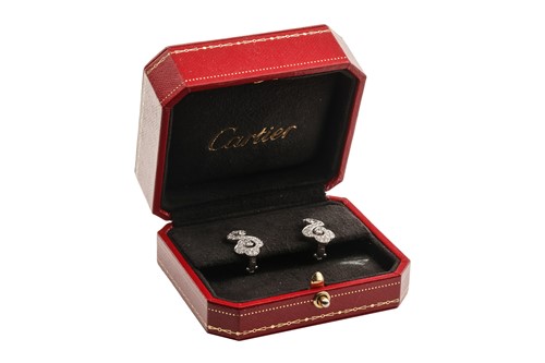 Lot 267 - Cartier - a pair of diamond-set scrolling...