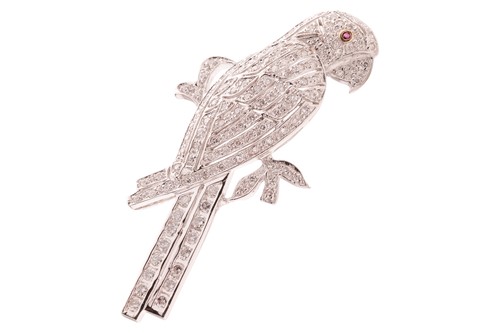 Lot 107 - A diamond-set parrot brooch, perching on a...