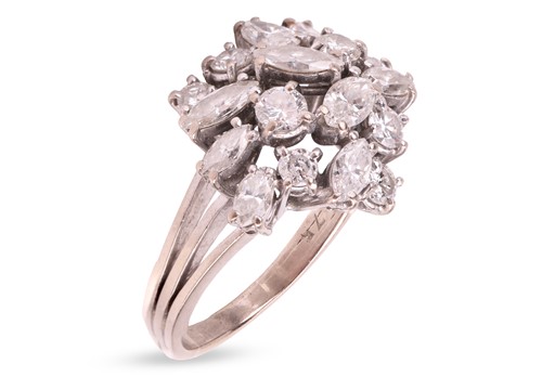 Lot 137 - A diamond cluster ring, comprising a central...