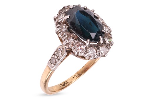 Lot 214 - A sapphire and diamond halo ring, centred with...