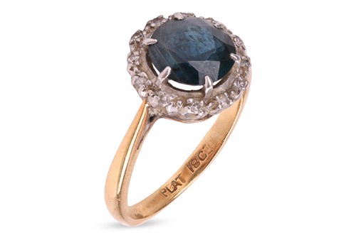 Lot 218 - A sapphire and diamond halo ring, consisting...